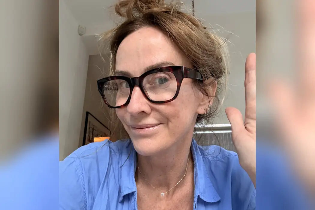 Trish, 51, founder of Bondi Body, smiling and waving in a blue shirt