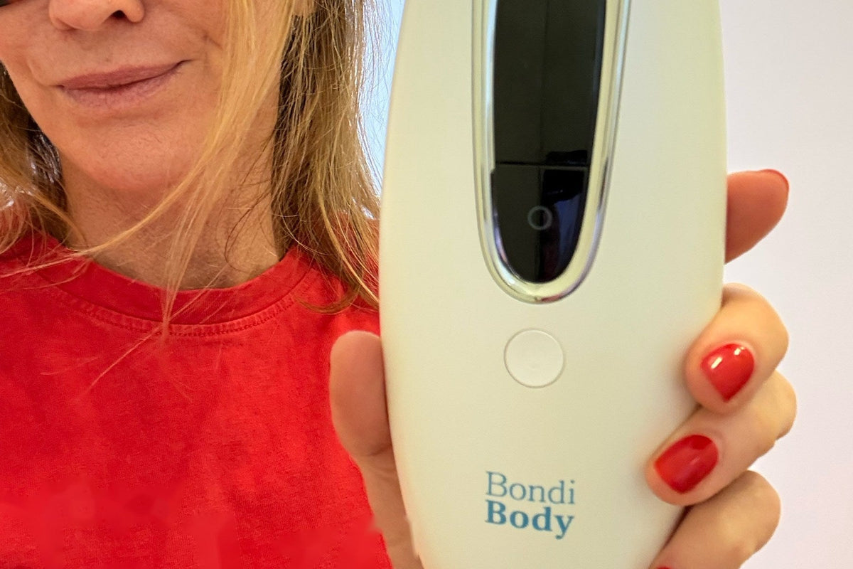 Trish, founder of Bondi Body, holding the Bondi Body V2 IPL device